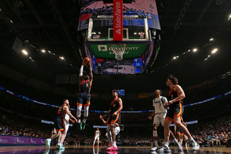 OKLAHOMA CITY, OK - APRIL 14: Luguentz Dort #5 of the Oklahoma City Thunder grabs a rebound during the game against the Dallas Mavericks  on April 14, 2024 at Paycom Arena in Oklahoma City, Oklahoma. NOTE TO USER: User expressly acknowledges and agrees that, by downloading and or using this photograph, User is consenting to the terms and conditions of the Getty Images License Agreement. Mandatory Copyright Notice: Copyright 2024 NBAE (Photo by Zach Beeker/NBAE via Getty Images)