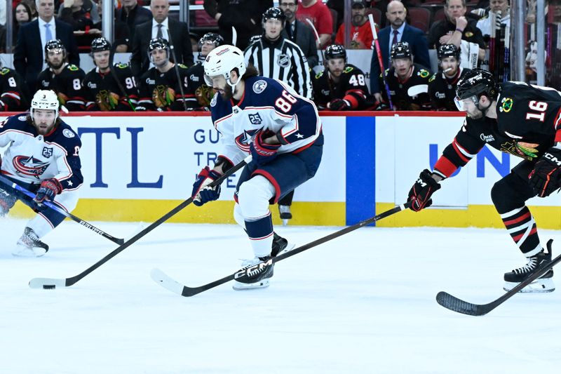 Jan 30, 2026; Chicago, Illinois, USA;  Columbus Blue Jackets right wing Kirill Marchenko (86)  moves the puck against Chicago Blackhawks center Jason Dickinson (16) during the first period at the United Center. Mandatory Credit: Matt Marton-Imagn Images