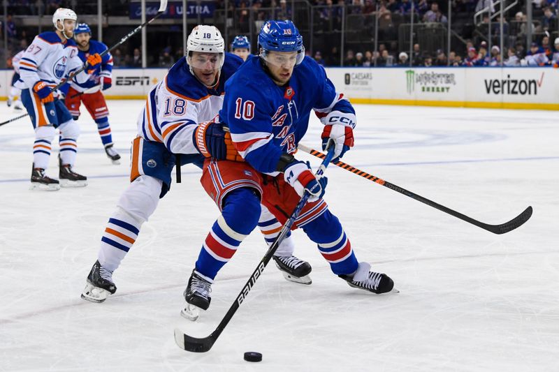 Dec 22, 2023; New York, New York, USA;  Edmonton Oilers left wing Zach Hyman (18) and home New York Rangers left wing Artemi Panarin (10) battle for the puck during the third period at Madison Square Garden. Mandatory Credit: Dennis Schneidler-USA TODAY Sports