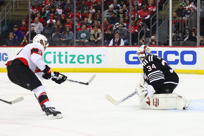 Mar 23, 2024; Newark, New Jersey, USA; Ottawa Senators right wing Mathieu Joseph (21) scores a goal on New Jersey Devils goaltender Jake Allen (34) during the first period at Prudential Center. Mandatory Credit: Ed Mulholland-USA TODAY Sports