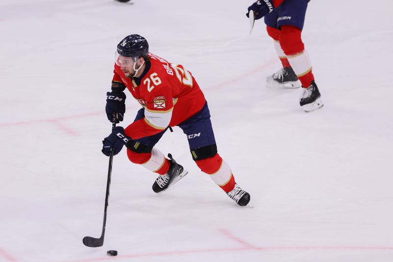 Apr 9, 2024; Sunrise, Florida, USA; Florida Panthers defenseman Uvis Balinskis (26) moves the puck against the Ottawa Senators during the third period at Amerant Bank Arena. Mandatory Credit: Sam Navarro-USA TODAY Sports