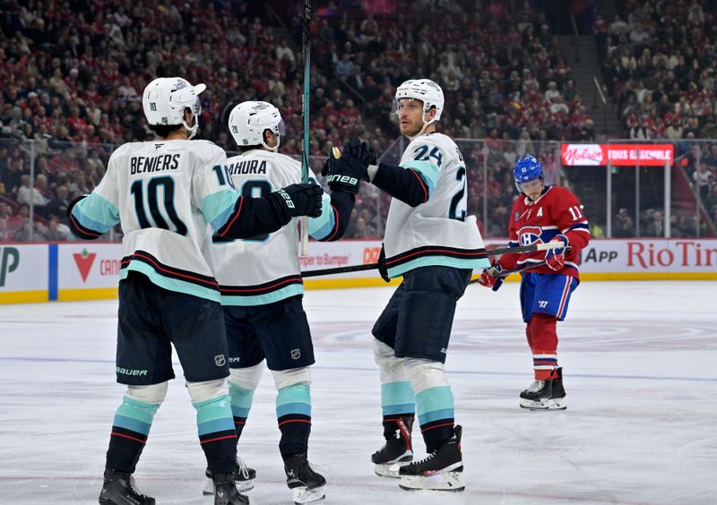 Oct 14, 2025; Montreal, Quebec, CAN; Seattle Kraken defenseman Jamie Oleksiak (24) celebrates with teammates after scoring a goal against the Montreal Canadiens during the third period at the Bell Centre. Mandatory Credit: Eric Bolte-Imagn Images