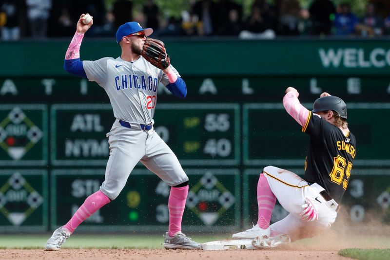 May 12, 2024; Pittsburgh, Pennsylvania, USA;  Chicago Cubs second baseman Miles Mastrobuoni (20) throws to first base after forcing Pittsburgh Pirates center fielder Jack Suwinski (65) out at second base during the tenth inning at PNC Park. The Cubs won 5-4 in ten innings. Mandatory Credit: Charles LeClaire-USA TODAY Sports