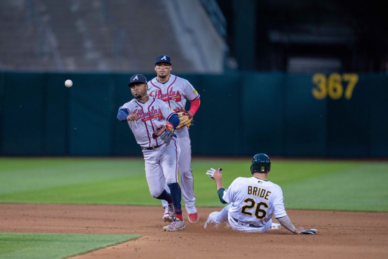 May 30, 2023; Oakland, California, USA;  Atlanta Braves second baseman Ozzie Albies (1) completes the double play as Oakland Athletics third baseman Jonah Bride (26) slides into second base during the seventh inning at Oakland-Alameda County Coliseum. Mandatory Credit: Neville E. Guard-USA TODAY Sports