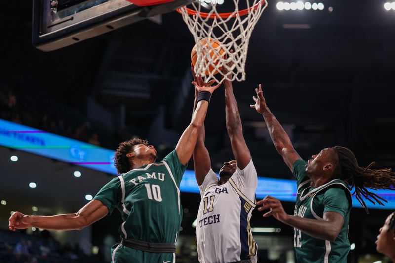 Dec 28, 2025; Atlanta, Georgia, USA; Georgia Tech Yellow Jackets forward Baye Ndongo (11) goes up for a rebound with Florida A&M Rattlers forward Kaleb Washington (10) and forward Tyler Shirley (22) in the first half at McCamish Pavilion. Mandatory Credit: Brett Davis-Imagn Images