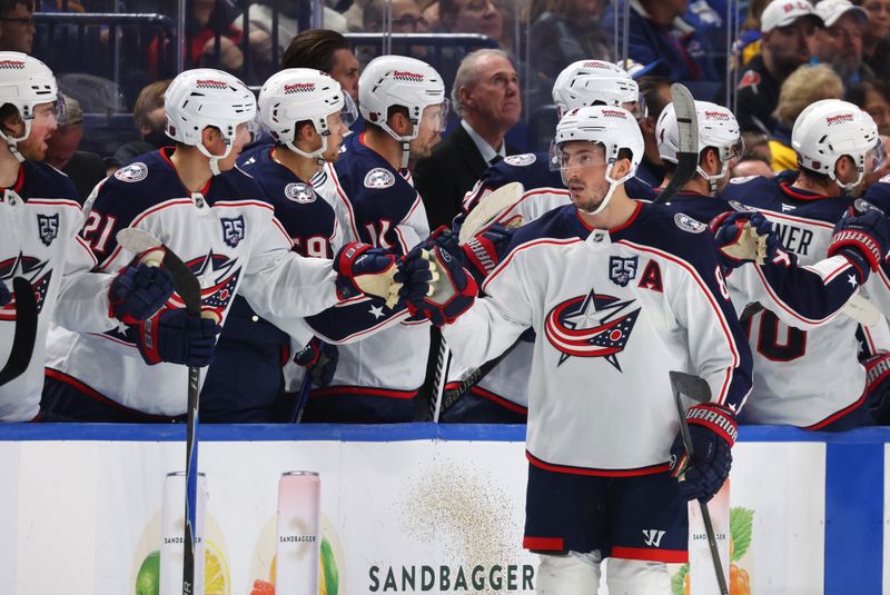 Oct 28, 2025; Buffalo, New York, USA;  Columbus Blue Jackets defenseman Zach Werenski (8) celebrates his goal with teammates during the second period against the Buffalo Sabres at KeyBank Center. Mandatory Credit: Timothy T. Ludwig-Imagn Images