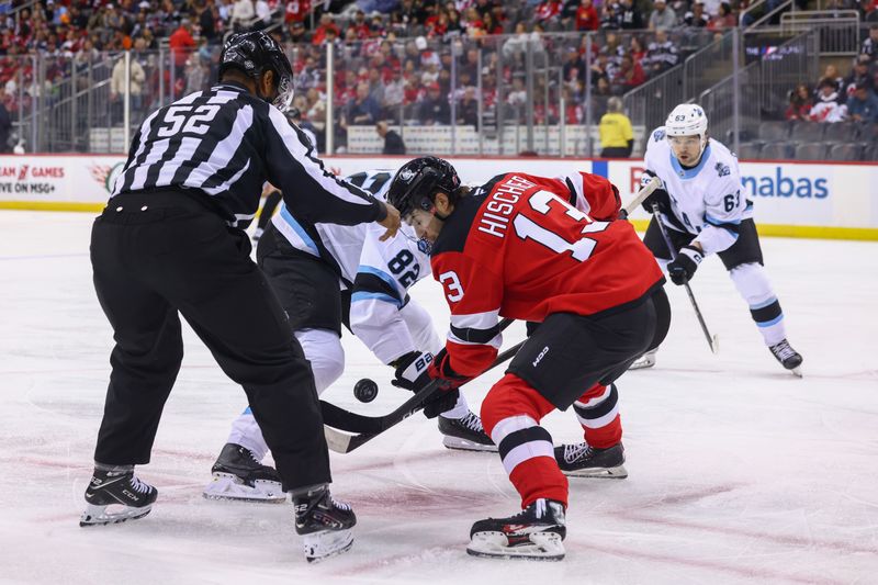 Oct 14, 2024; Newark, New Jersey, USA; Utah Hockey Club center Kevin Stenlund (82) and New Jersey Devils center Nico Hischier (13) face off during the first period at Prudential Center. Mandatory Credit: Ed Mulholland-Imagn Images