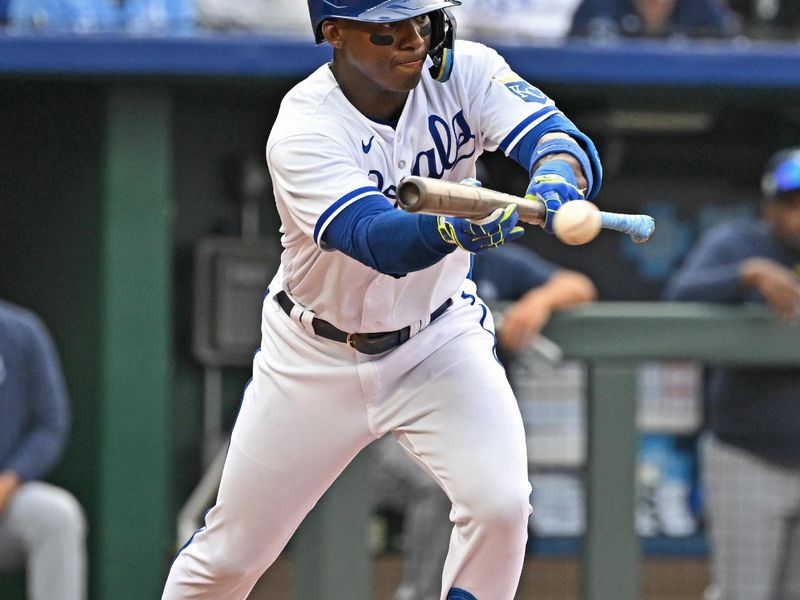 Jul 15, 2023; Kansas City, Missouri, USA;  Kansas City Royals right fielder Dairon Blanco (44) lays down a bunt for a single in the third inning against the Tampa Bay Rays at Kauffman Stadium. Mandatory Credit: Peter Aiken-USA TODAY Sports