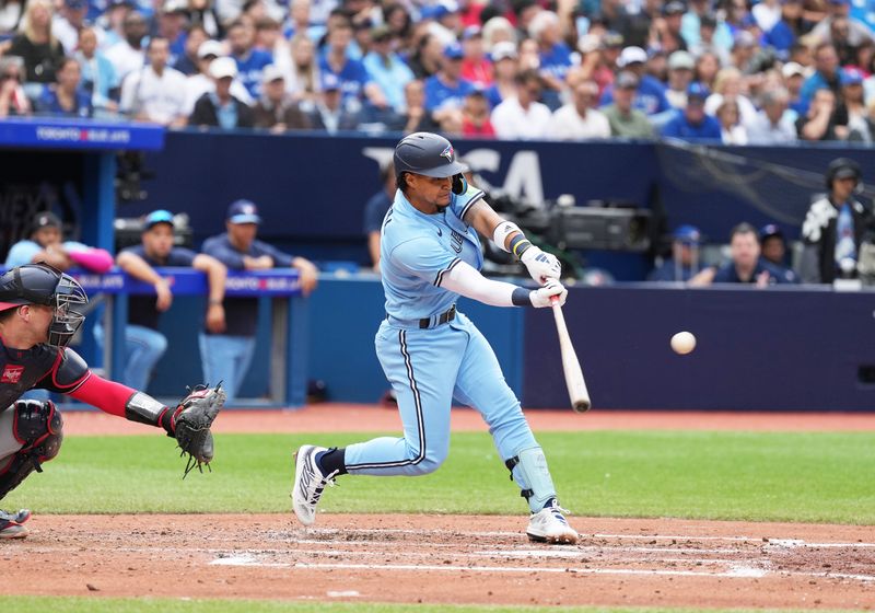 Aug 30, 2023; Toronto, Ontario, CAN; Toronto Blue Jays second baseman Santiago Espinal (5) hits an RBI double against the Washington Nationals during the fourth inning at Rogers Centre. Mandatory Credit: Nick Turchiaro-USA TODAY Sports