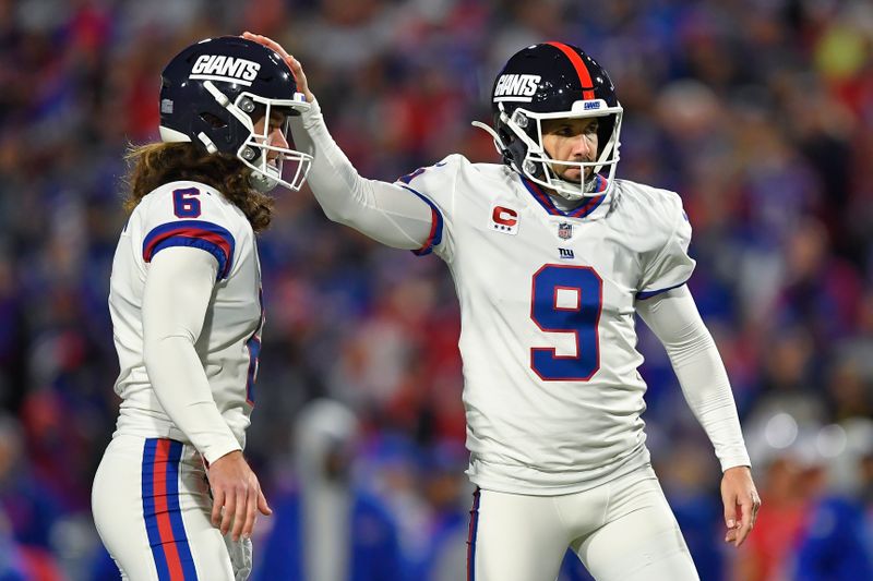 New York Giants kicker Graham Gano, right, celebrates with punter Jamie Gillan after kicking a field goal during the first half of an NFL football game against the Buffalo Bills in Orchard Park, N.Y., Sunday, Oct. 15, 2023. (AP Photo/Adrian Kraus)