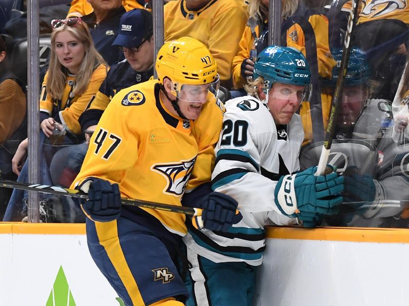 Mar 19, 2024; Nashville, Tennessee, USA; Nashville Predators right wing Michael McCarron (47) hits San Jose Sharks left wing Fabian Zetterlund (20) during the third period at Bridgestone Arena. Mandatory Credit: Christopher Hanewinckel-USA TODAY Sports