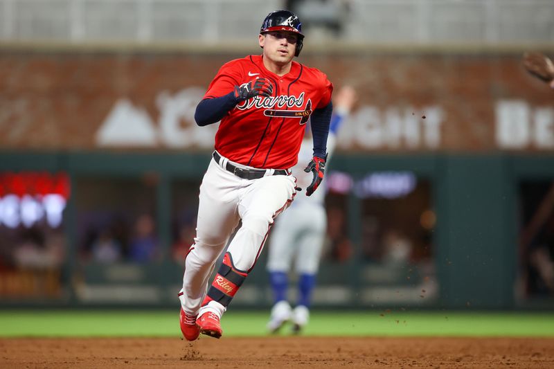 Sep 28, 2023; Atlanta, Georgia, USA; Atlanta Braves third baseman Austin Riley (27) hits a triple against the Chicago Cubs in the third inning at Truist Park. Mandatory Credit: Brett Davis-USA TODAY Sports