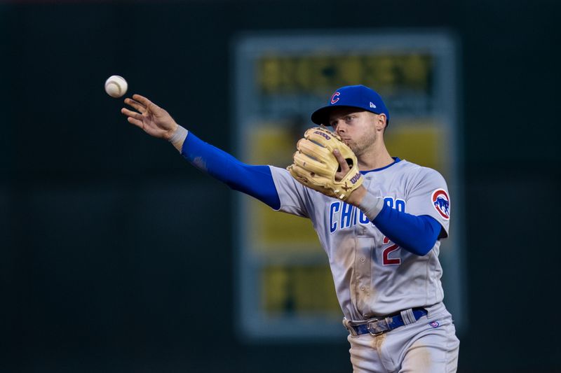 Apr 18, 2023; Oakland, California, USA; Chicago Cubs second baseman Nico Hoerner (2) throws to first base for an out against the Oakland Athletics during the third inning at RingCentral Coliseum. Mandatory Credit: John Hefti-USA TODAY Sports