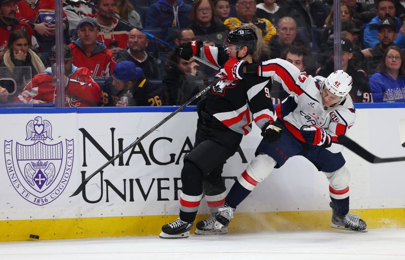 Jan 6, 2025; Buffalo, New York, USA;  Buffalo Sabres right wing Nicolas Aube-Kubel (96) and Washington Capitals defenseman Martin Fehervary (42) go after a loose puck during the second period at KeyBank Center. Mandatory Credit: Timothy T. Ludwig-Imagn Images