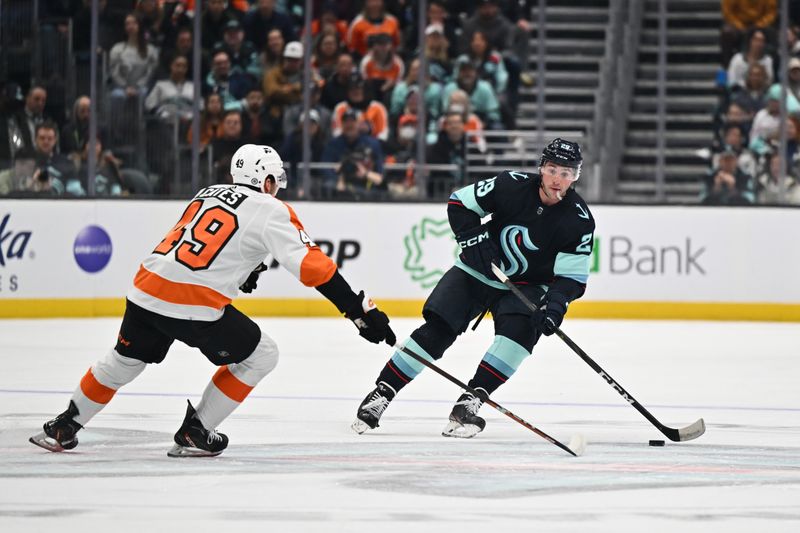 Feb 16, 2023; Seattle, Washington, USA; Seattle Kraken defenseman Vince Dunn (29) advances the puck while being defended by Philadelphia Flyers left wing Noah Cates (49) during the first period at Climate Pledge Arena. Mandatory Credit: Steven Bisig-USA TODAY Sports