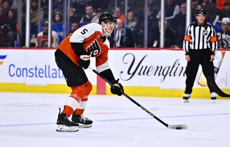 Feb 8, 2024; Philadelphia, Pennsylvania, USA; Philadelphia Flyers defenseman Egor Zamula (5) controls the puck against the Winnipeg Jets in the first period at Wells Fargo Center. Mandatory Credit: Kyle Ross-USA TODAY Sports