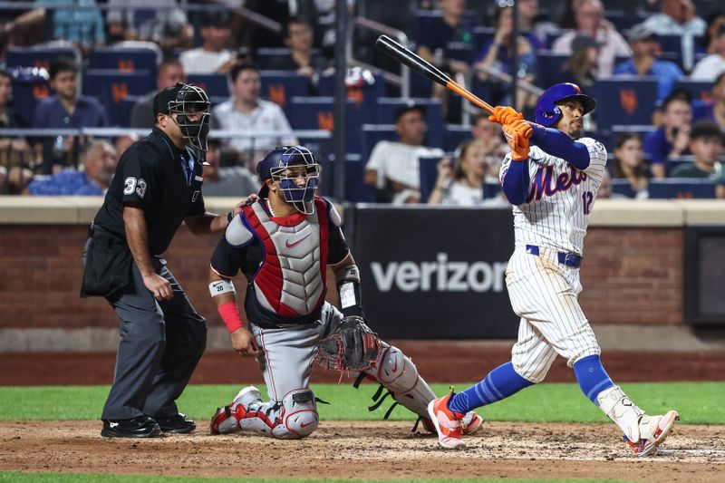 Jul 9, 2024; New York City, New York, USA;  New York Mets shortstop Francisco Lindor (12) hits a two run home run in the sixth inning against the Washington Nationals at Citi Field. Mandatory Credit: Wendell Cruz-USA TODAY Sports