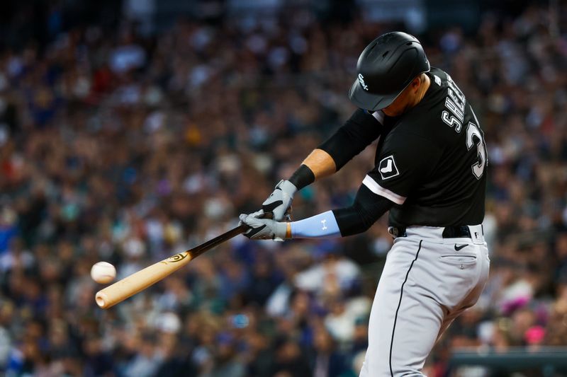 Jun 18, 2023; Seattle, Washington, USA; Chicago White Sox right fielder Gavin Sheets (32) hits a single against the Seattle Mariners during the third inning at T-Mobile Park. Mandatory Credit: Joe Nicholson-USA TODAY Sports