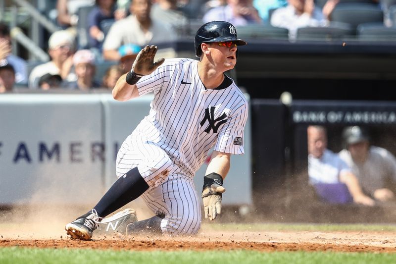 Aug 25, 2024; Bronx, New York, USA;  New York Yankees first baseman DJ LeMahieu (26) slides safely at home plate in the second inning against the Colorado Rockies at Yankee Stadium. Mandatory Credit: Wendell Cruz-USA TODAY Sports