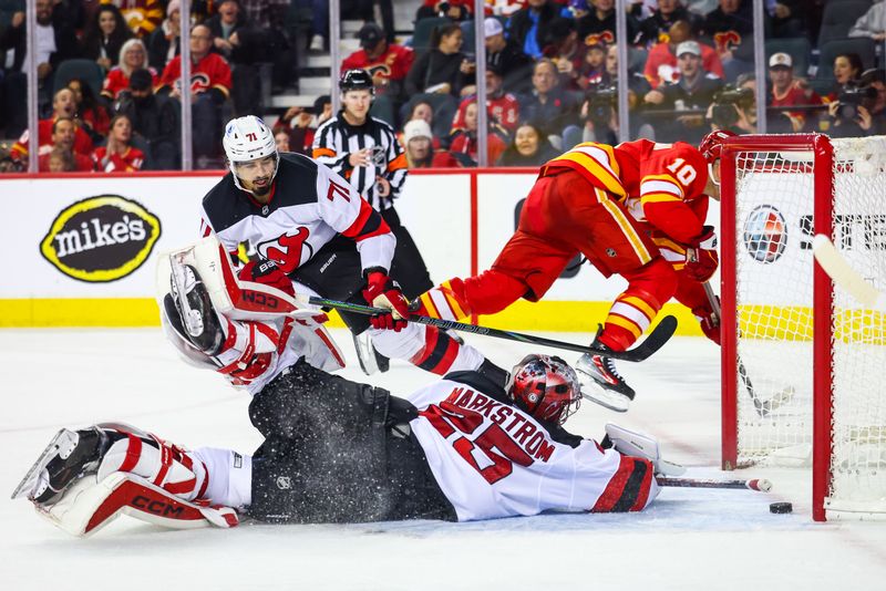 Nov 1, 2024; Calgary, Alberta, CAN; Calgary Flames center Jonathan Huberdeau (10) scores a goal against New Jersey Devils goaltender Jacob Markstrom (25) during the third period at Scotiabank Saddledome. Mandatory Credit: Sergei Belski-Imagn Images