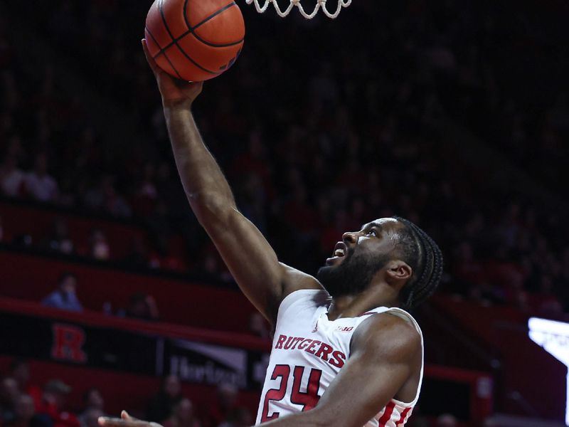 Nov 27, 2023; Piscataway, New Jersey, USA; Rutgers Scarlet Knights guard Austin Williams (24) lays the ball up during the second half against the St. Peter's Peacocks at Jersey Mike's Arena. Mandatory Credit: Vincent Carchietta-USA TODAY Sports