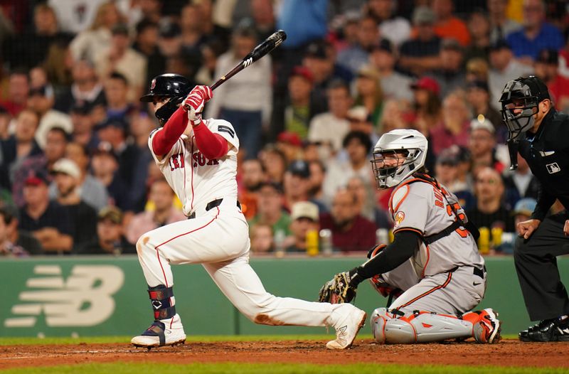 Sep 9, 2024; Boston, Massachusetts, USA; Boston Red Sox first baseman Connor Wong (12) get a base hit against the Baltimore Orioles in the sixth inning at Fenway Park. Mandatory Credit: David Butler II-Imagn Images