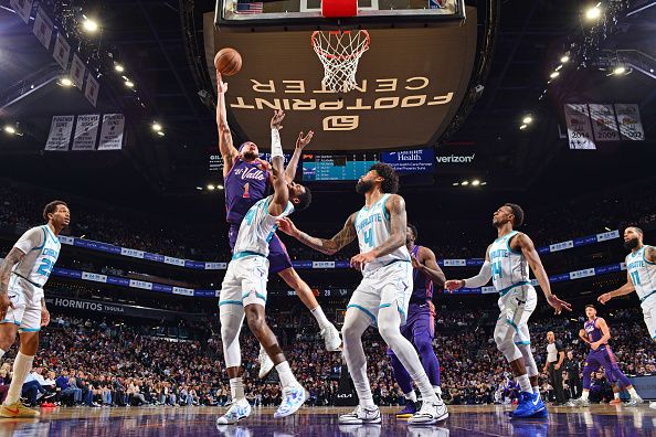 PHOENIX, AZ - DECEMBER 29: Devin Booker #1 of the Phoenix Suns drives to the basket during the game against the Charlotte Hornets on December 29 2023 at Footprint Center in Phoenix, Arizona. NOTE TO USER: User expressly acknowledges and agrees that, by downloading and or using this photograph, user is consenting to the terms and conditions of the Getty Images License Agreement. Mandatory Copyright Notice: Copyright 2023 NBAE (Photo by Barry Gossage/NBAE via Getty Images)