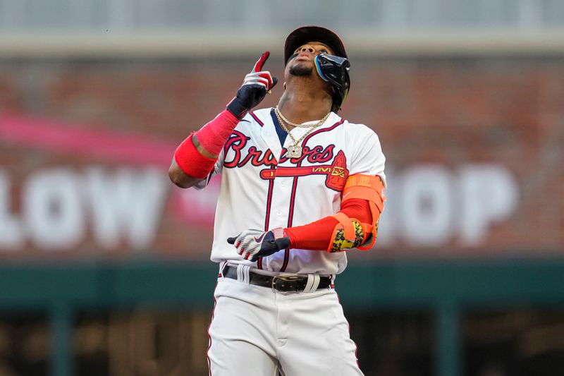 Apr 12, 2023; Cumberland, Georgia, USA; Atlanta Braves right fielder Ronald Acuna Jr. (13) reacts after hitting a double against the Cincinnati Reds during the first inning at Truist Park. Mandatory Credit: Dale Zanine-USA TODAY Sports