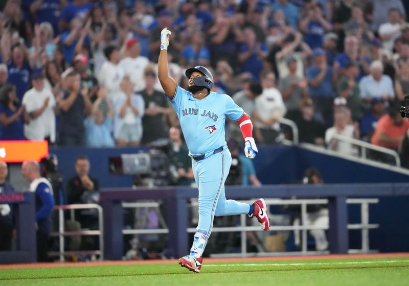 Jul 23, 2024; Toronto, Ontario, CAN; Toronto Blue Jays first base Vladimir Guerrero Jr. (27) runs the bases and celebrates after hitting a home run against the Tampa Bay Rays during the sixth inning at Rogers Centre. Mandatory Credit: Nick Turchiaro-USA TODAY Sports