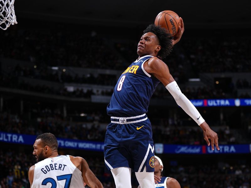 DENVER, CO - APRIL 10: Peyton Watson #8 of the Denver Nuggets dunks the ball during the game against the Minnesota Timberwolves on April 10, 2024 at the Ball Arena in Denver, Colorado. NOTE TO USER: User expressly acknowledges and agrees that, by downloading and/or using this Photograph, user is consenting to the terms and conditions of the Getty Images License Agreement. Mandatory Copyright Notice: Copyright 2024 NBAE (Photo by Garrett Ellwood/NBAE via Getty Images)