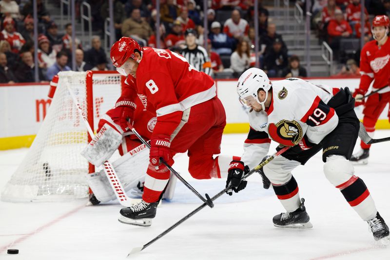 Jan 7, 2025; Detroit, Michigan, USA; Detroit Red Wings defenseman Ben Chiarot (8) and Ottawa Senators right wing Drake Batherson (19) battle for the puck in the first period at Little Caesars Arena. Mandatory Credit: Rick Osentoski-Imagn Images