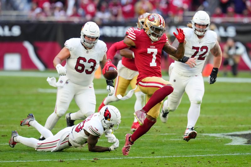 San Francisco 49ers cornerback Charvarius Ward (7) returns an interception for a touchdown past Arizona Cardinals wide receiver Greg Dortch, bottom, during the first half of an NFL football game Sunday, Dec. 17, 2023, in Glendale, Ariz. (AP Photo/Ross D. Franklin)