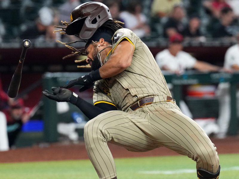 May 3, 2024; Phoenix, Arizona, USA; San Diego Padres outfielder Fernando Tatis Jr. (23) dodges a pitch against the Arizona Diamondbacks during the ninth inning at Chase Field. Mandatory Credit: Joe Camporeale-USA TODAY Sports