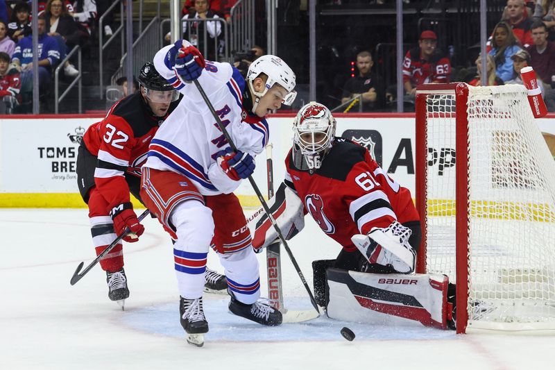 Sep 30, 2024; Newark, New Jersey, USA; New Jersey Devils goaltender Jeremy Brodeur (60) makes a save on New York Rangers left wing Adam Sykora (38) during the first period at Prudential Center. Mandatory Credit: Ed Mulholland-Imagn Images