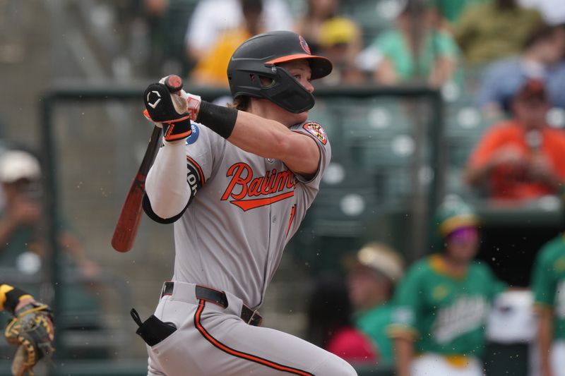 Jun 8, 2025; West Sacramento, California, USA; Baltimore Orioles second baseman Jackson Holliday (7) hits a single against the Athletics during the seventh inning at Sutter Health Park. Mandatory Credit: Darren Yamashita-Imagn Images