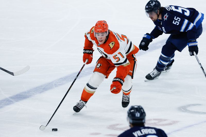 Mar 10, 2026; Winnipeg, Manitoba, CAN;  Anaheim Ducks defenseman Olen Zellweger (51) skates away from Winnipeg Jets forward Mark Scheifele (55) during the first period at Canada Life Centre. Mandatory Credit: Terrence Lee-Imagn Images