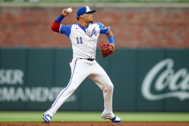 Apr 27, 2024; Atlanta, Georgia, USA; Atlanta Braves shortstop Orlando Arcia (11) throws a runner out at first against the Cleveland Guardians in the second inning at Truist Park. Mandatory Credit: Brett Davis-USA TODAY Sports
