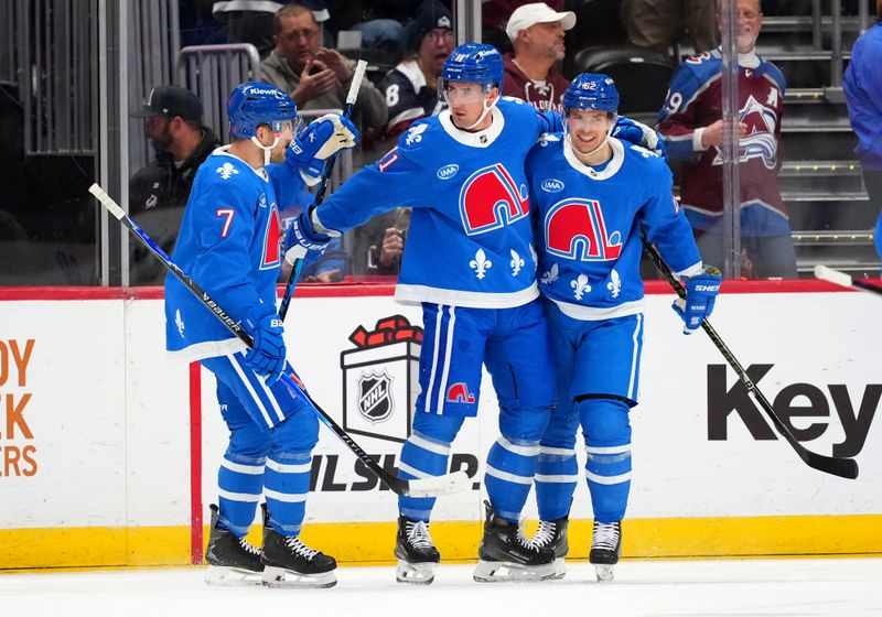 Nov 29, 2025; Denver, Colorado, USA; Colorado Avalanche center Brock Nelson (11) celebrates his first goal with defenseman Devon Toews (7) and left wing Artturi Lehkonen (62) in the first period against the Montreal Canadiens at Ball Arena. Mandatory Credit: Ron Chenoy-Imagn Images