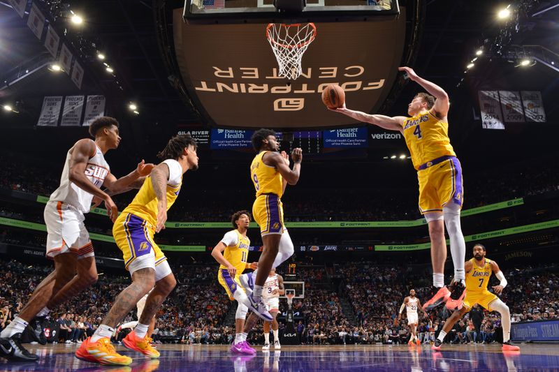 PHOENIX, AZ - OCTOBER 17: Dalton Knecht #4 of the Los Angeles Lakers goes up for the rebound during the game against the Phoenix Suns during a NBA Preseason game on October 17, 2024 at Footprint Center in Phoenix, Arizona. NOTE TO USER: User expressly acknowledges and agrees that, by downloading and or using this photograph, user is consenting to the terms and conditions of the Getty Images License Agreement. Mandatory Copyright Notice: Copyright 2024 NBAE (Photo by Barry Gossage/NBAE via Getty Images)