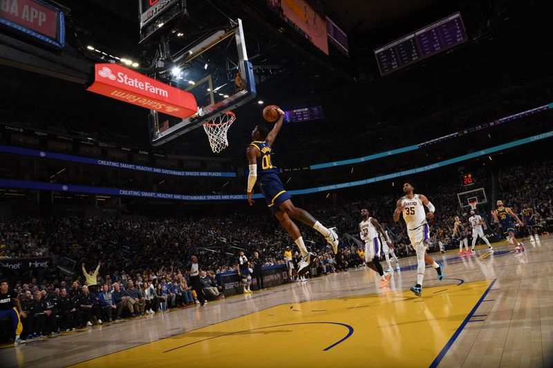 SAN FRANCISCO, CA - JANUARY 27: Jonathan Kuminga #00 of the Golden State Warriors dunks the ball during the game against the Los Angeles Lakers on January 27, 2024 at Chase Center in San Francisco, California. NOTE TO USER: User expressly acknowledges and agrees that, by downloading and or using this photograph, user is consenting to the terms and conditions of Getty Images License Agreement. Mandatory Copyright Notice: Copyright 2024 NBAE (Photo by Noah Graham/NBAE via Getty Images)