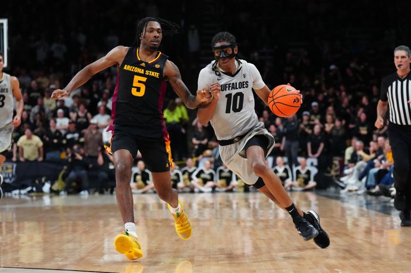 Feb 8, 2024; Boulder, Colorado, USA; Colorado Buffaloes forward Cody Williams (10) drives at Arizona State Sun Devils guard Jamiya Neal (5) in the second half at the CU Events Center. Mandatory Credit: Ron Chenoy-USA TODAY Sports