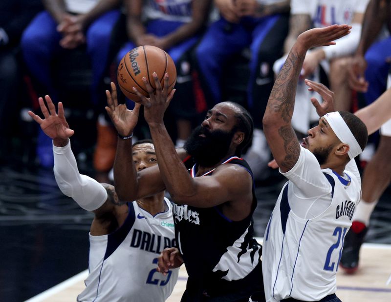 LOS ANGELES, CALIFORNIA - APRIL 23: James Harden #1 of the LA Clippers attempts a shot between Daniel Gafford #21 and P.J. Washington #25 of the Dallas Mavericks during the first half at Crypto.com Arena on April 23, 2024 in Los Angeles, California. User is consenting to the terms and conditions of the Getty Images License Agreement. (Photo by Harry How/Getty Images)