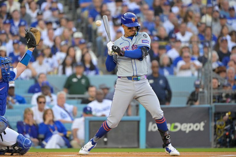 Oct 20, 2024; Los Angeles, California, USA; New York Mets third baseman Mark Vientos (27) avoids a pitch in the first inning against the Los Angeles Dodgers during game six of the NLCS for the 2024 MLB playoffs at Dodger Stadium. Mandatory Credit: Jayne Kamin-Oncea-Imagn Images