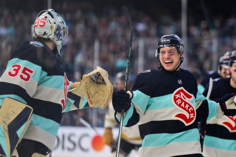 Jan 1, 2024; Seattle, Washington, USA; Seattle Kraken goaltender Joey Daccord (35) and center Yanni Gourde (37) celebrate after Gourde scored a goal against the Vegas Golden Knights during the 3rd period in the 2024 Winter Classic ice hockey game at T-Mobile Park. Mandatory Credit: Steven Bisig-USA TODAY Sports