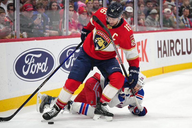 Dec 29, 2023; Sunrise, Florida, USA; Florida Panthers center Aleksander Barkov (16) and New York Rangers center Vincent Trocheck (16) battle for the puck during the second period at Amerant Bank Arena. Mandatory Credit: Jasen Vinlove-USA TODAY Sports