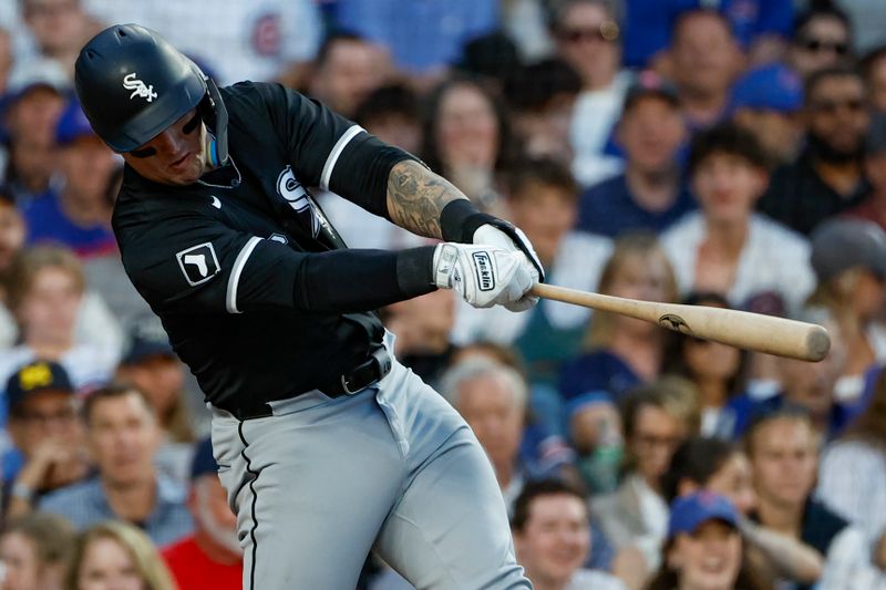 Jun 5, 2024; Chicago, Illinois, USA; Chicago White Sox catcher Korey Lee (26) hits an RBI-single against the Chicago Cubs during the fourth inning at Wrigley Field. Mandatory Credit: Kamil Krzaczynski-USA TODAY Sports