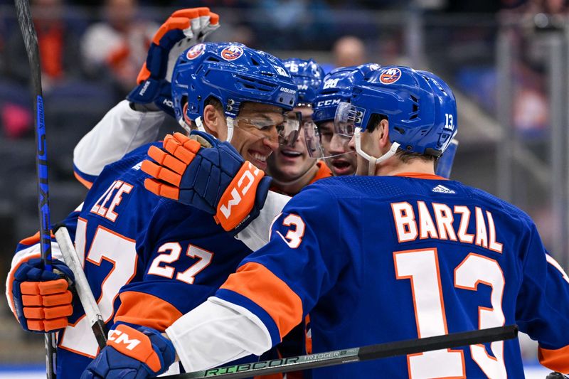 Mar 23, 2024; Elmont, New York, USA;  New York Islanders left wing Anders Lee (27) celebrates his goal with New York Islanders center Mathew Barzal (13) against the Winnipeg Jets during the second period at UBS Arena. Mandatory Credit: Dennis Schneidler-USA TODAY Sports