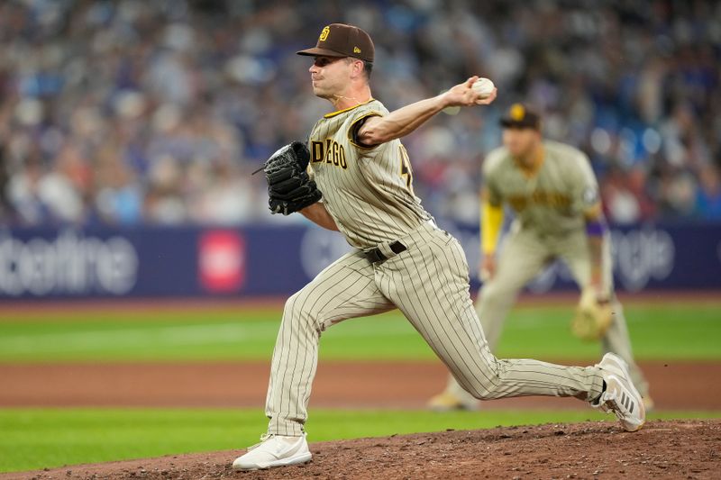 Jul 18, 2023; Toronto, Ontario, CAN; San Diego Padres pitcher Tom Cosgrove (59) pitches to the Toronto Blue Jays during the seventh inning at Rogers Centre. Mandatory Credit: John E. Sokolowski-USA TODAY Sports