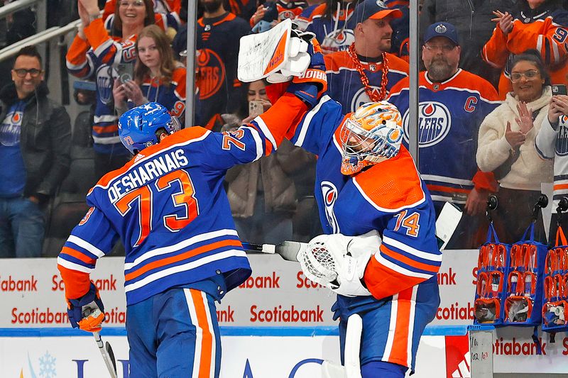 Jan 27, 2024; Edmonton, Alberta, CAN; Edmonton Oilers defensemen Vincent Desharnais (73) and goaltender Stuart Skinner (74) celebrate the Oilers 4-1 victory over the Nashville Predators. It is the Oilers 16th straight win at Rogers Place. Mandatory Credit: Perry Nelson-USA TODAY Sports