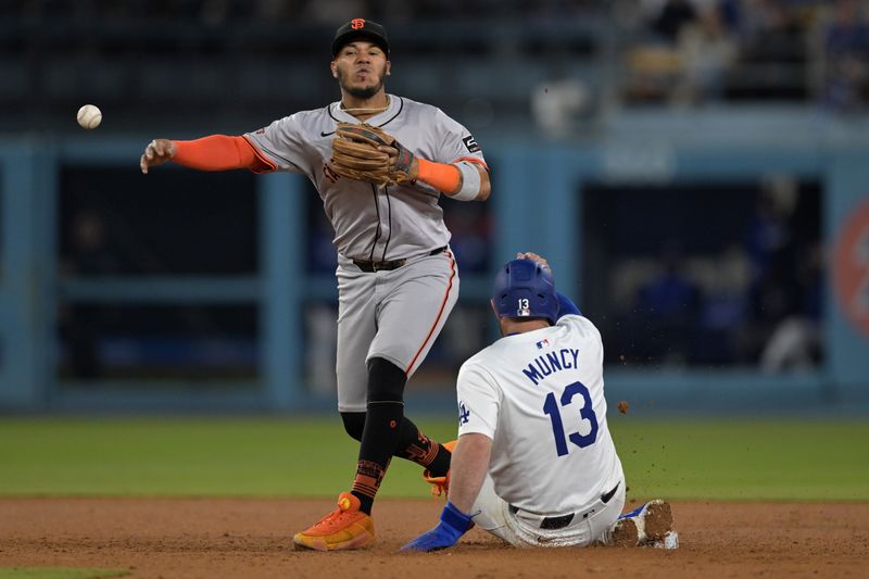 Apr 2, 2024; Los Angeles, California, USA;  Los Angeles Dodgers third baseman Max Muncy (13) is out at second as San Francisco Giants second baseman Thairo Estrada (39) throws to first in the the seventh inning at Dodger Stadium. Mandatory Credit: Jayne Kamin-Oncea-USA TODAY Sports